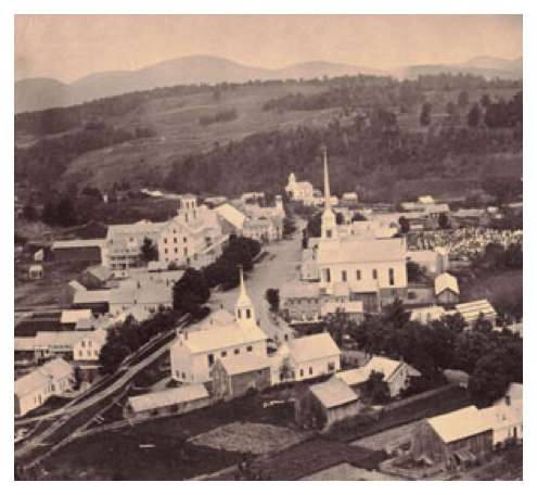 An black-and-white photo of a small Vermont village taken from the air.